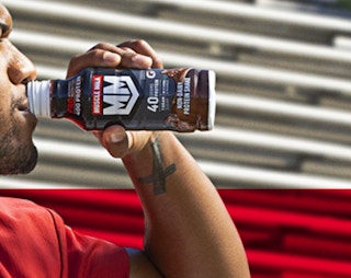 a person drinking a protein drink