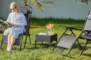 a woman sitting on zero gravity chairs