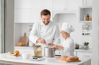 a father and son using a sourdough starter to make sourdough