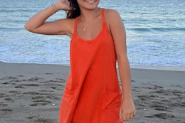 a woman wearing an athletic dress on a beach