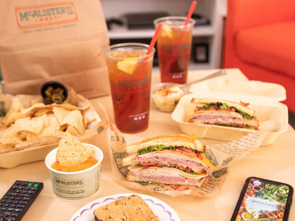 Food and drinks from McAlister's Deli on a table.