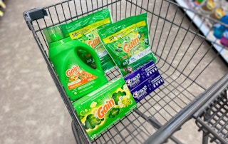 a cart with gain laundry detergent and crest toothpaste