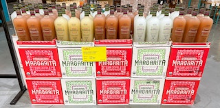 margarita in bottles on the sales floor at whole foods with sales sign