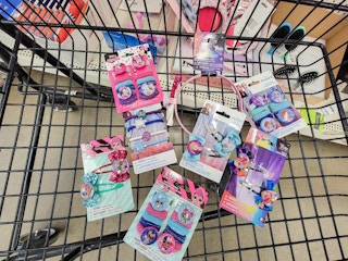 cart full of character themed hair accessories, clips, and ties featuring minnie mouse, trolls, frozen, and lol surprise