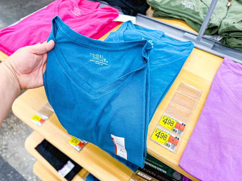 hand holding time and tru shirt at walmart