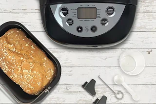 a bread maker next to fresh bread