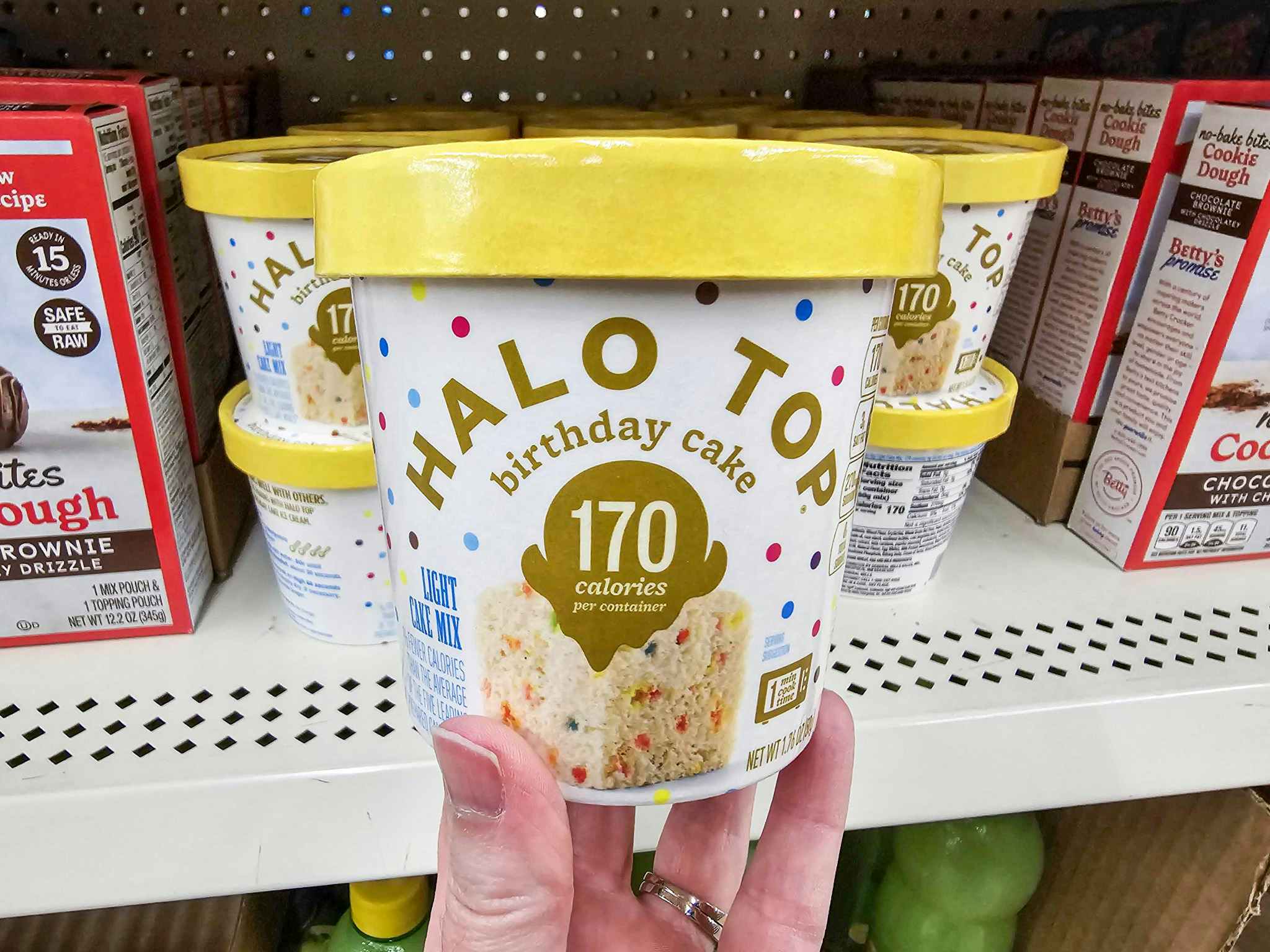 person holding an individual cup of halo top cake mix