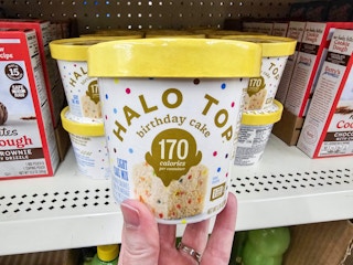 person holding an individual cup of halo top cake mix