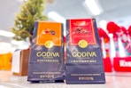 2 bags of godiva masterpiece chocolates on a shelf