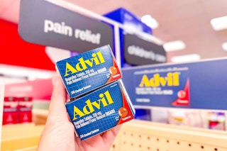 person holding 2 boxes of advil