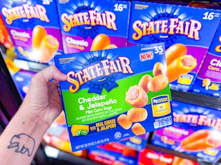 hand holding a box of state fair cheddar jalepeno mini corn dogs in walmart freezer section