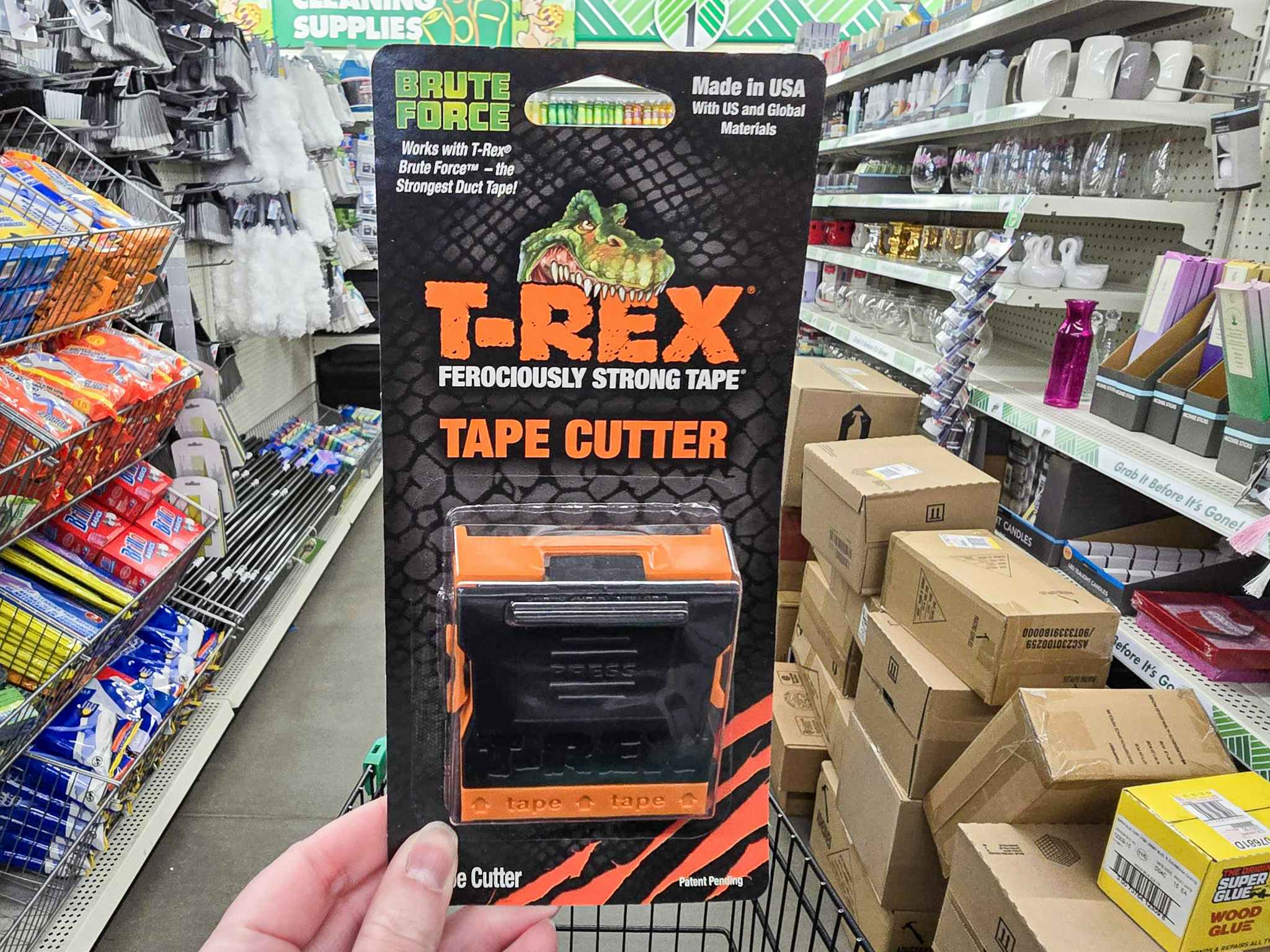 person holding a trex tape cutter in the dollar tree aisle