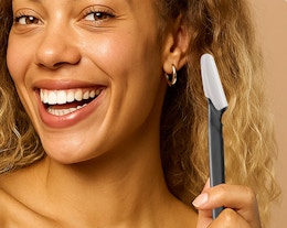 a person holding a dermaplane razor