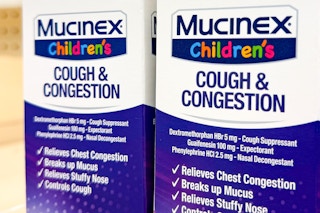 Two Mucinex Children's Cold Medicine side-by-side (close up)