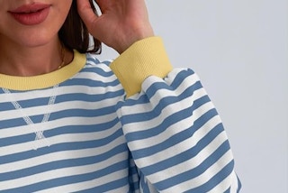 a woman wearing a blue and yellow sweatshirt