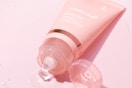 a pink tube of a face mask on a pink background