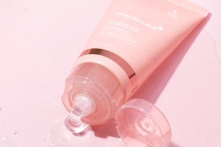 a pink open tube on a pink surface