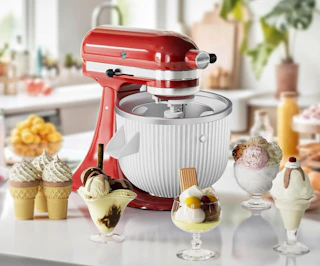 a KitchenAid mixer with an ice cream maker next to bowls of ice cream