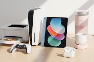 airpod pros, ipad, printer, keurig, and playstation 5 console on a table