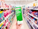 hand holding multipurpose contact lens solution in walgreens