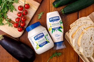 hellmann's vegan dressing and spread jar and squeeze bottle on a table with ingredients
