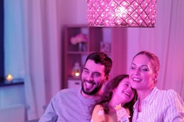 a family under color changing light bulbs