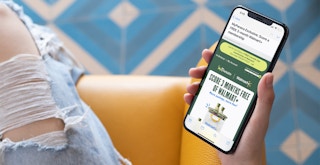 a person on their iphone looking at panera rewards for walmart plus members