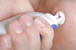 a man using a wart remover