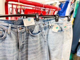 Jeans hanging on hangers