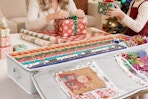 a woman and girl using a wrapping paper organizer
