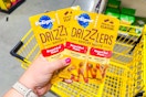 hand holding pedigree drizzlers at dollar general