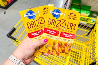 hand holding pedigree drizzlers at dollar general