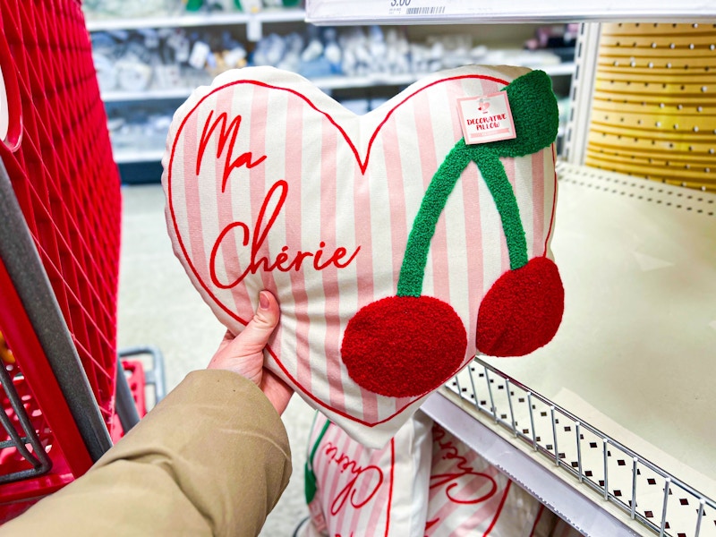 hand holding a ma cherie throw pillow