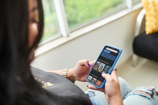 someone on their phone using DirecTV stream