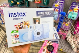 hand holding the instax fujifilm bundle in blue