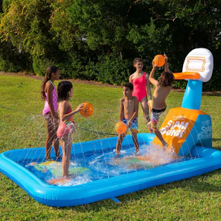 kids playing in an inflatable splash pad with a basketball hoop