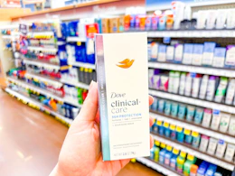 a person holding deodorant in a store aisle