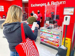 woman standing in returns line with bag and receipt