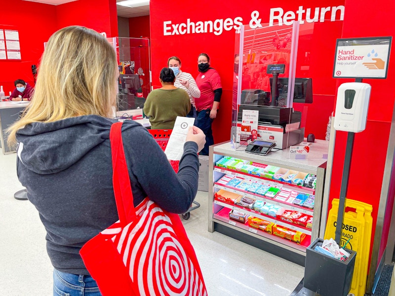 woman standing in returns line with bag and receipt
