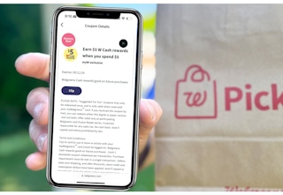 hand holding smartphone with booster coupon screenshot next to Walgreens paper bag