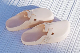 Stock image of a pair of light rose Birkenstock Adjustable Recovery Clogs