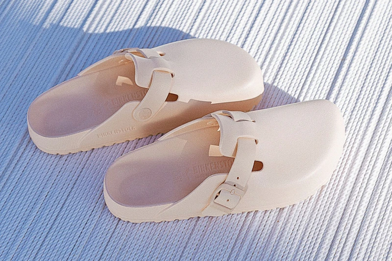 Stock image of a pair of light rose Birkenstock Adjustable Recovery Clogs