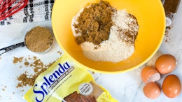 a package of splenda on a counter next to baking items in a bowl