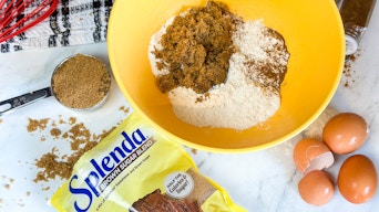 a package of splenda on a counter next to baking items in a bowl