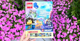 hand holding the lego life magazine outside