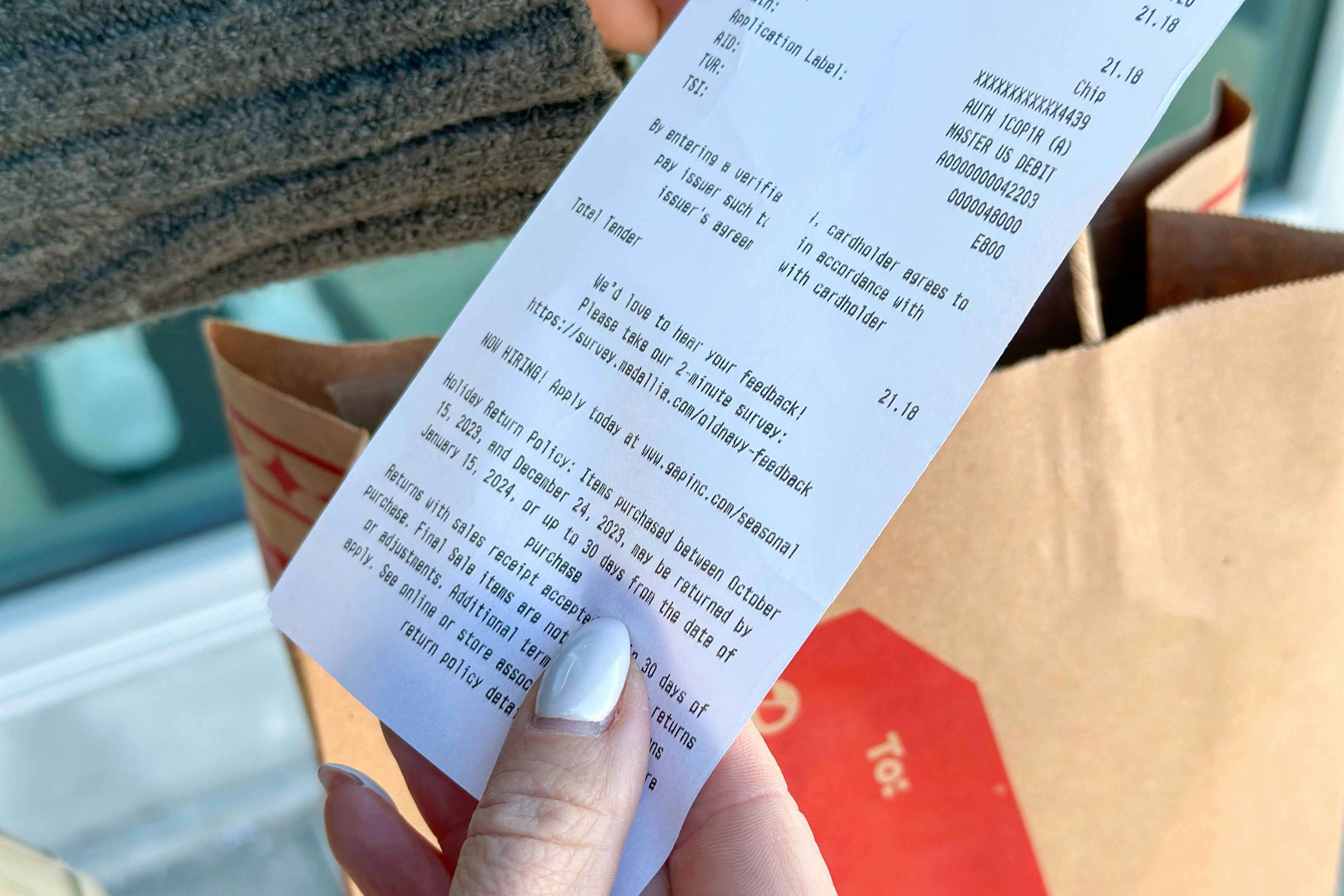 an old navy receipt being held 