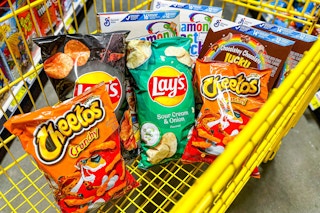 4 boxes of cereal, 2 bags of lay's and 2 bags of cheetos in a cart