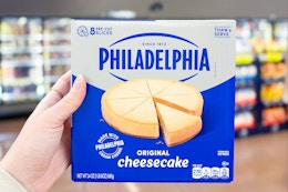 hand holding a philadelphia cheesecake