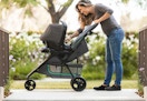person pushing a the Baby Trend travel system outside