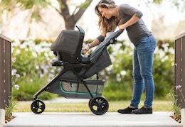 person pushing a the Baby Trend travel system outside